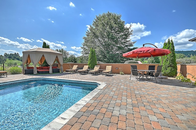 view of swimming pool with a patio and a gazebo