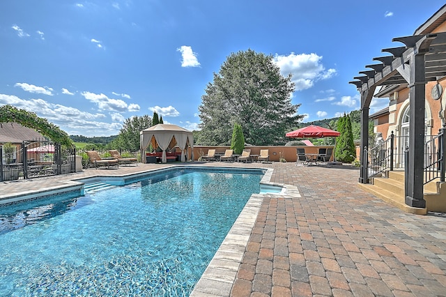 view of swimming pool featuring a pergola, a gazebo, and a patio area