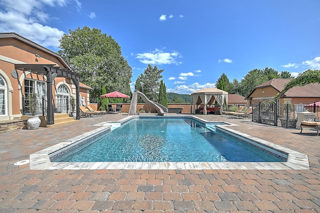 view of pool with a patio and a water slide