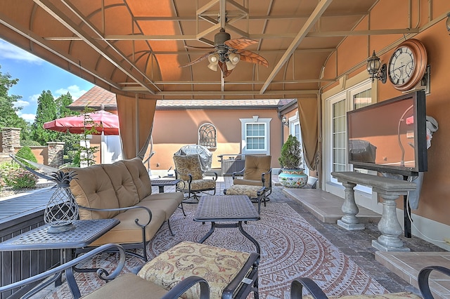 view of terrace with an outdoor living space and ceiling fan