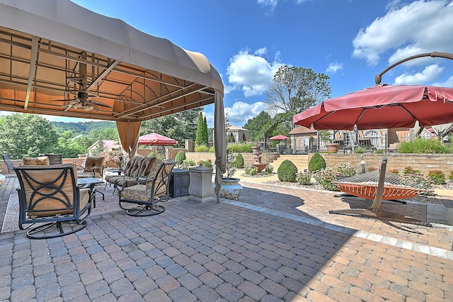 view of patio / terrace featuring ceiling fan and a gazebo