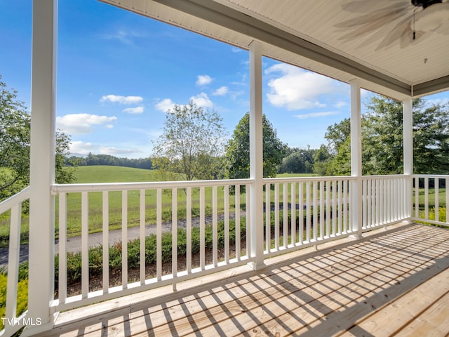 deck featuring a lawn and ceiling fan