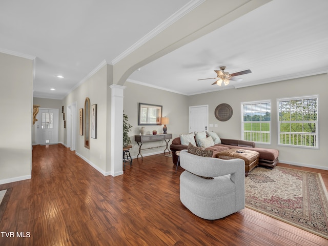 living room with crown molding, ceiling fan, dark hardwood / wood-style flooring, and ornate columns