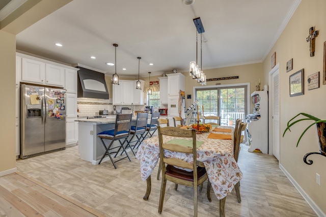 dining area featuring a chandelier, light tile floors, and crown molding