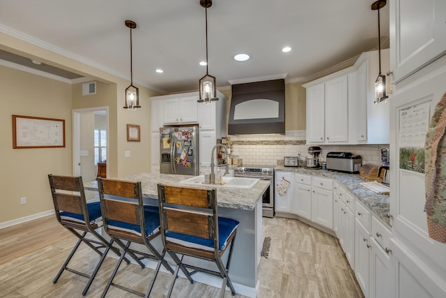 kitchen with hanging light fixtures, tasteful backsplash, appliances with stainless steel finishes, and light stone counters