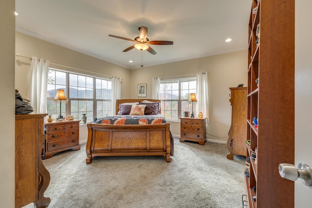 carpeted bedroom with ceiling fan and crown molding