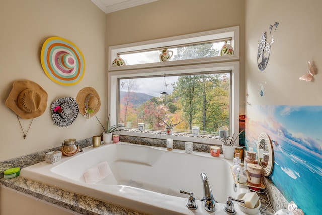 bathroom with a tub, crown molding, and plenty of natural light