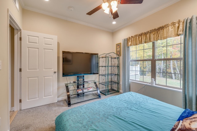 carpeted bedroom with ceiling fan and ornamental molding