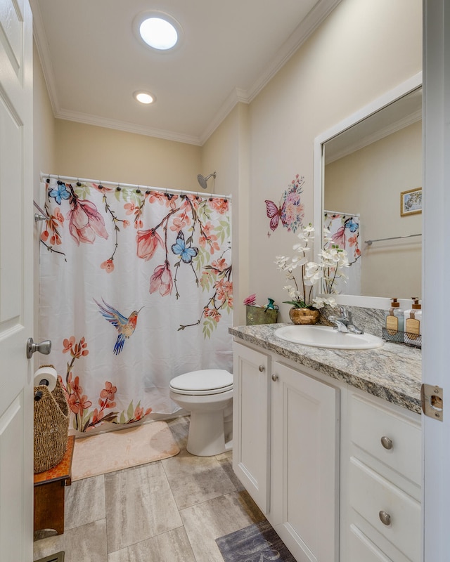 bathroom with tile flooring, ornamental molding, toilet, and vanity