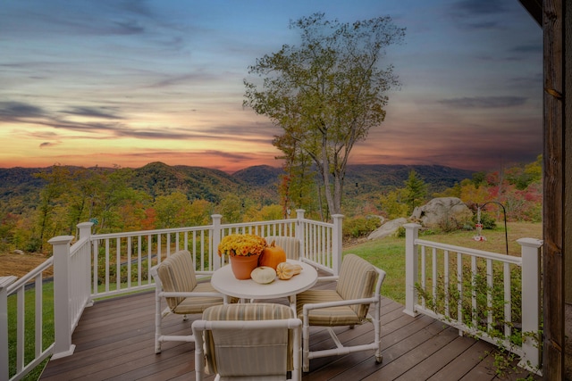 deck at dusk featuring a mountain view