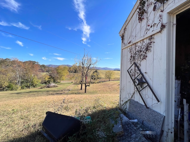 view of yard with a rural view