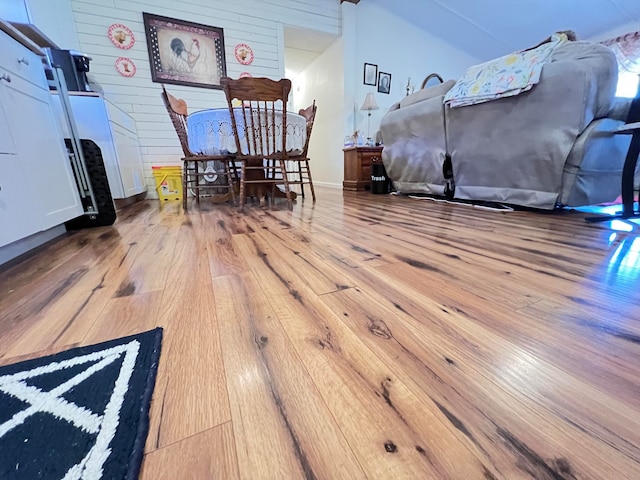 dining area featuring light hardwood / wood-style floors and wooden walls