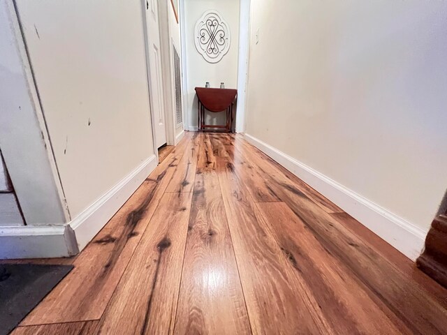 hall with light hardwood / wood-style flooring