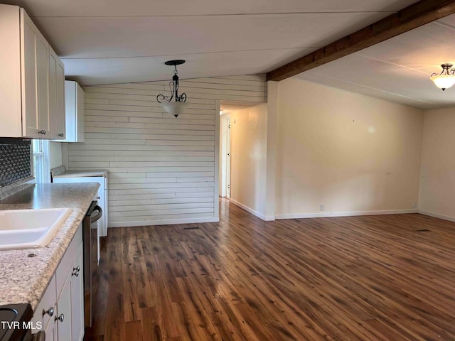 kitchen with wood walls, lofted ceiling with beams, dark hardwood / wood-style floors, decorative light fixtures, and white cabinetry