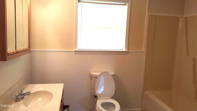 full bathroom with vanity, shower / bath combination, and toilet