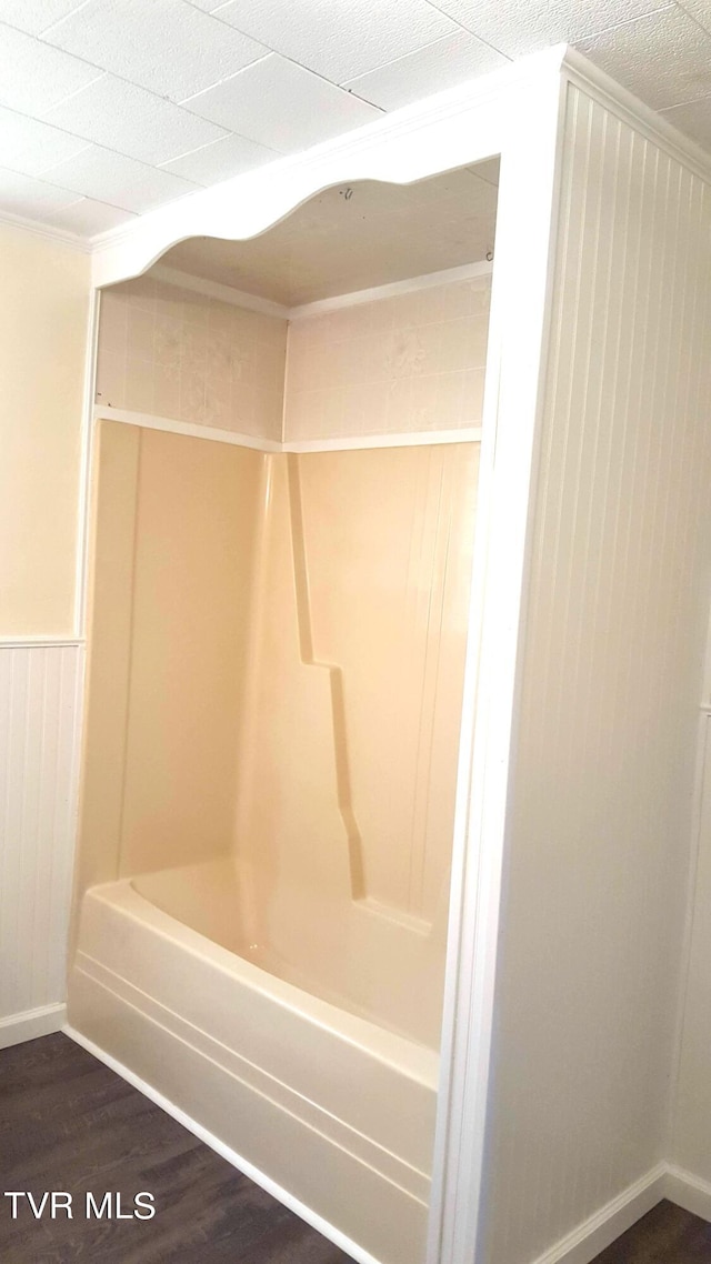 bathroom with shower / bathing tub combination and wood-type flooring