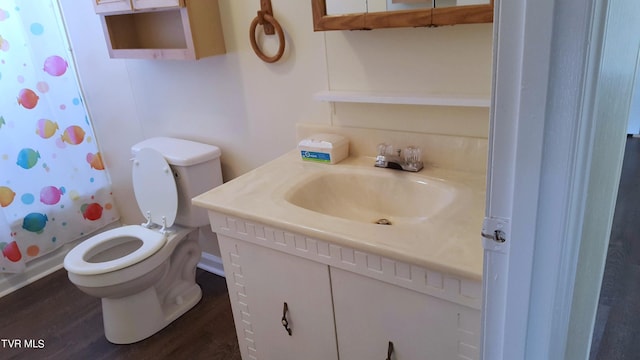 bathroom featuring vanity, hardwood / wood-style flooring, and toilet