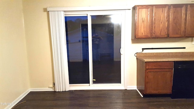 interior space with black dishwasher and dark wood-type flooring