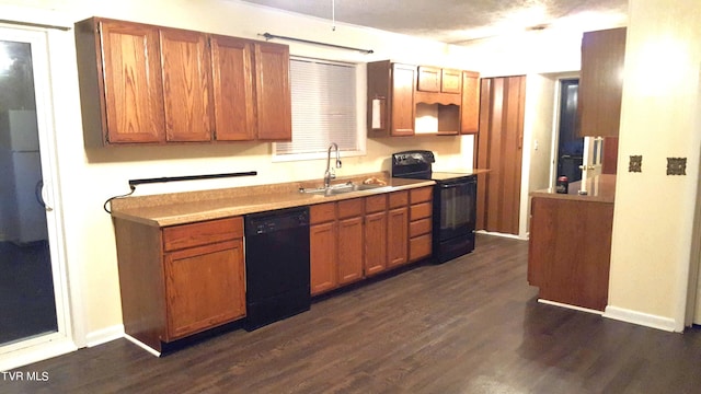 kitchen featuring sink, dark hardwood / wood-style flooring, and black appliances