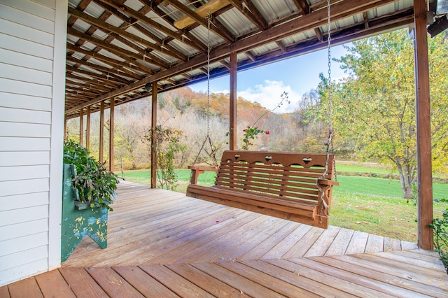 wooden deck featuring a lawn