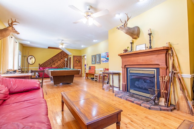 living room with pool table, ceiling fan, and light wood-type flooring