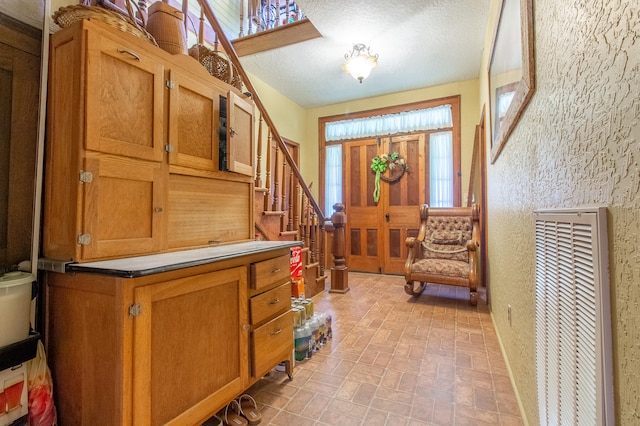 foyer featuring a textured ceiling