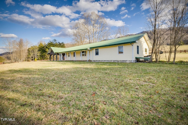 back of property featuring a lawn