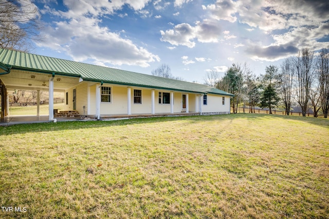 back of house featuring a lawn