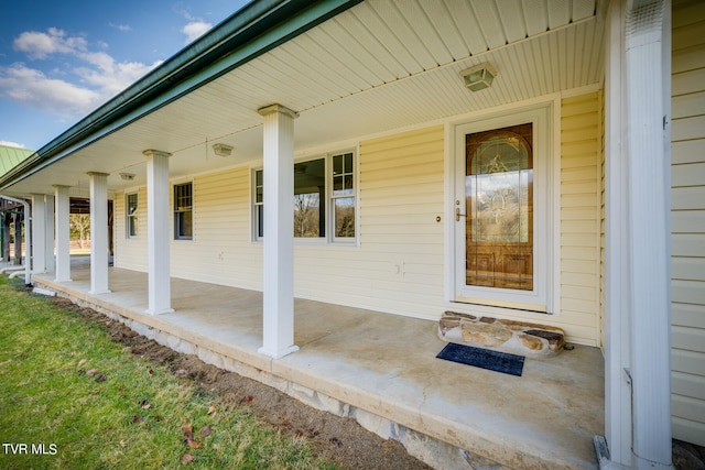 view of exterior entry with covered porch