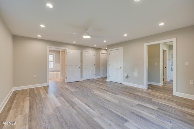 spare room featuring ceiling fan and light hardwood / wood-style flooring