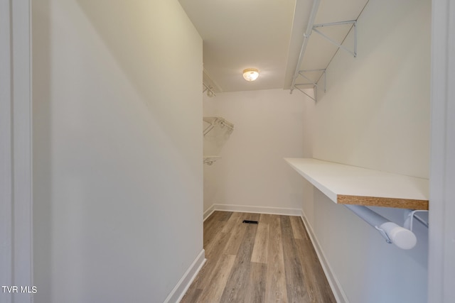 walk in closet featuring light hardwood / wood-style flooring