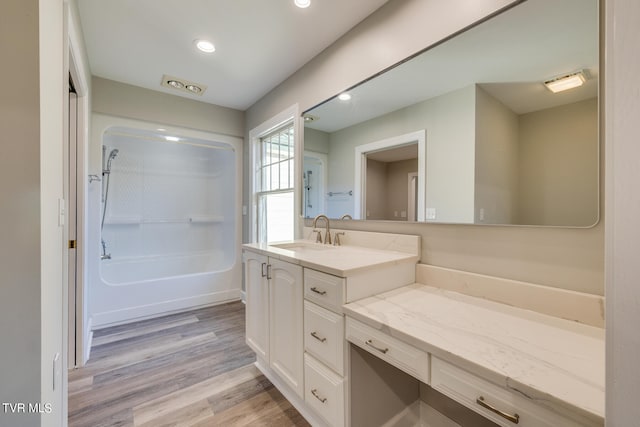 bathroom with vanity, bathtub / shower combination, and hardwood / wood-style floors