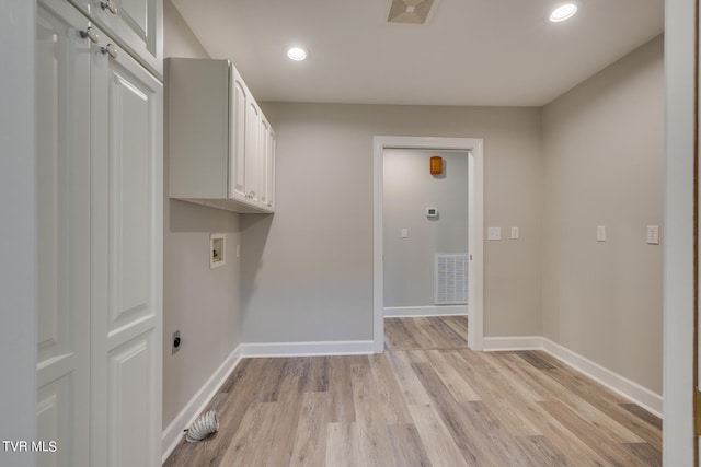 laundry area featuring hookup for a washing machine, cabinets, hookup for an electric dryer, and light wood-type flooring