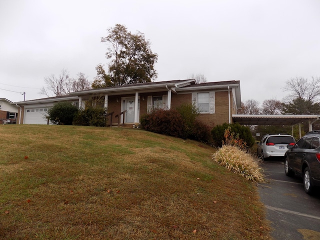 ranch-style house featuring a carport, a front yard, and a garage