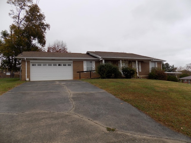 ranch-style house featuring a front lawn and a garage