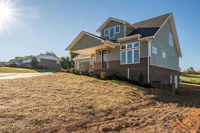 craftsman-style home with a garage and a front yard