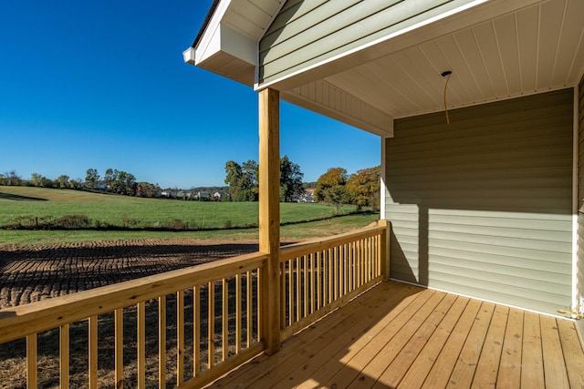 deck with a yard and a rural view