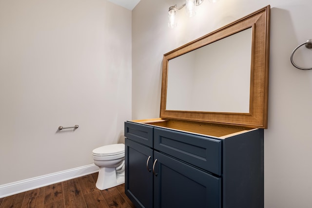 bathroom featuring hardwood / wood-style floors, toilet, and vanity