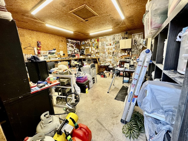 miscellaneous room with a workshop area and attic access