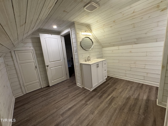 bathroom with wooden walls, wood ceiling, vaulted ceiling, wood finished floors, and vanity