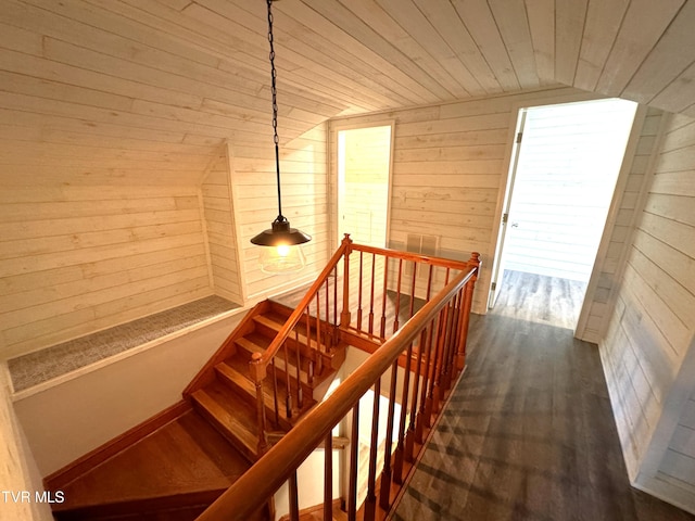 stairs with lofted ceiling, wood walls, wood-type flooring, and wood ceiling