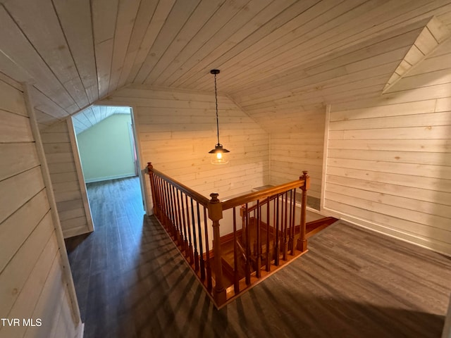 stairs with hardwood / wood-style floors, lofted ceiling, wooden walls, and wooden ceiling