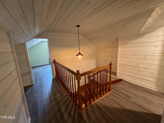 stairs featuring vaulted ceiling, wooden walls, wood ceiling, and wood finished floors