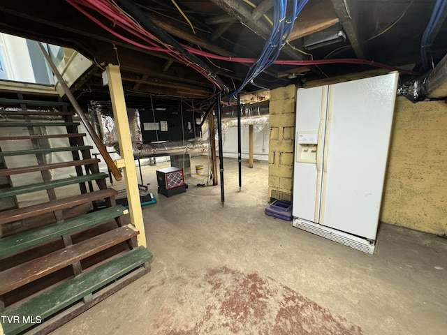 basement with white refrigerator with ice dispenser