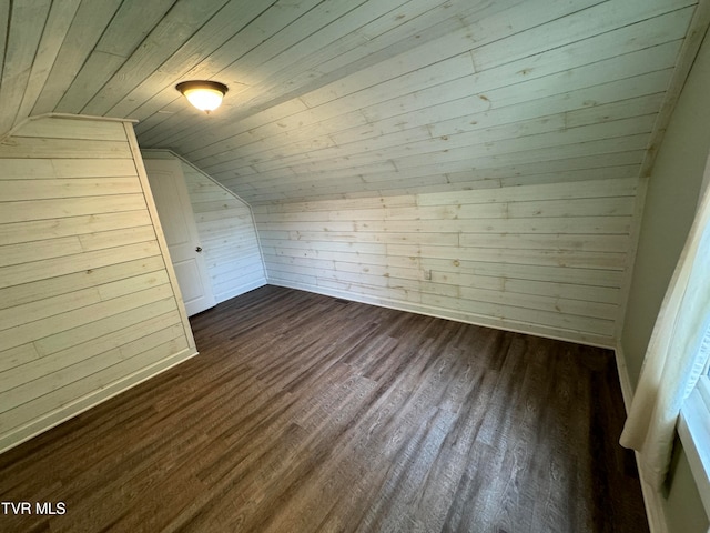 bonus room with dark wood-type flooring, vaulted ceiling, wooden ceiling, and wood walls