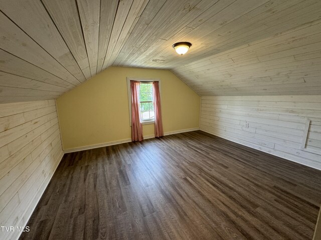 bonus room with lofted ceiling, wood walls, dark hardwood / wood-style flooring, and wood ceiling