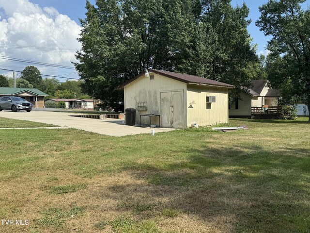 view of outbuilding featuring a yard