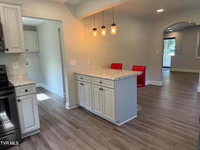 kitchen featuring black / electric stove, light stone countertops, white cabinets, and dark hardwood / wood-style floors