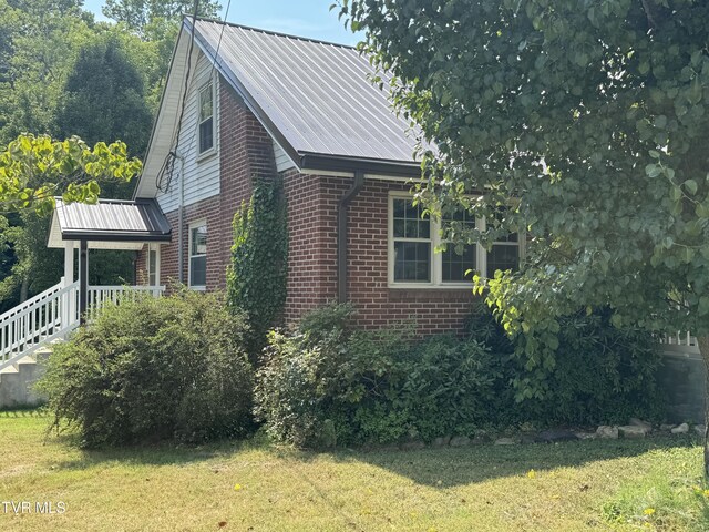 view of side of property with a yard