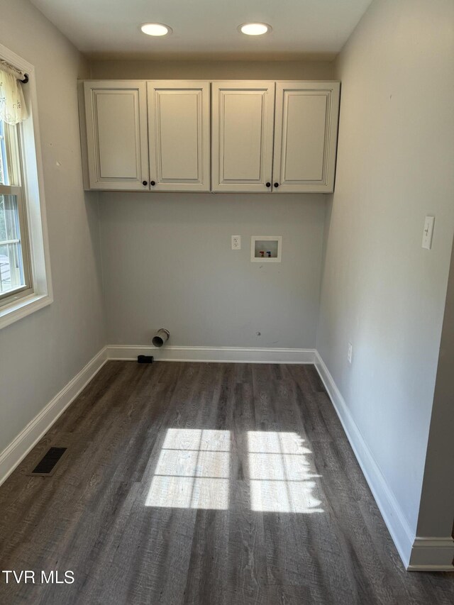 washroom featuring cabinets, washer hookup, and dark hardwood / wood-style floors